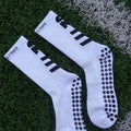 White socks with black stripes and patterns on grass
